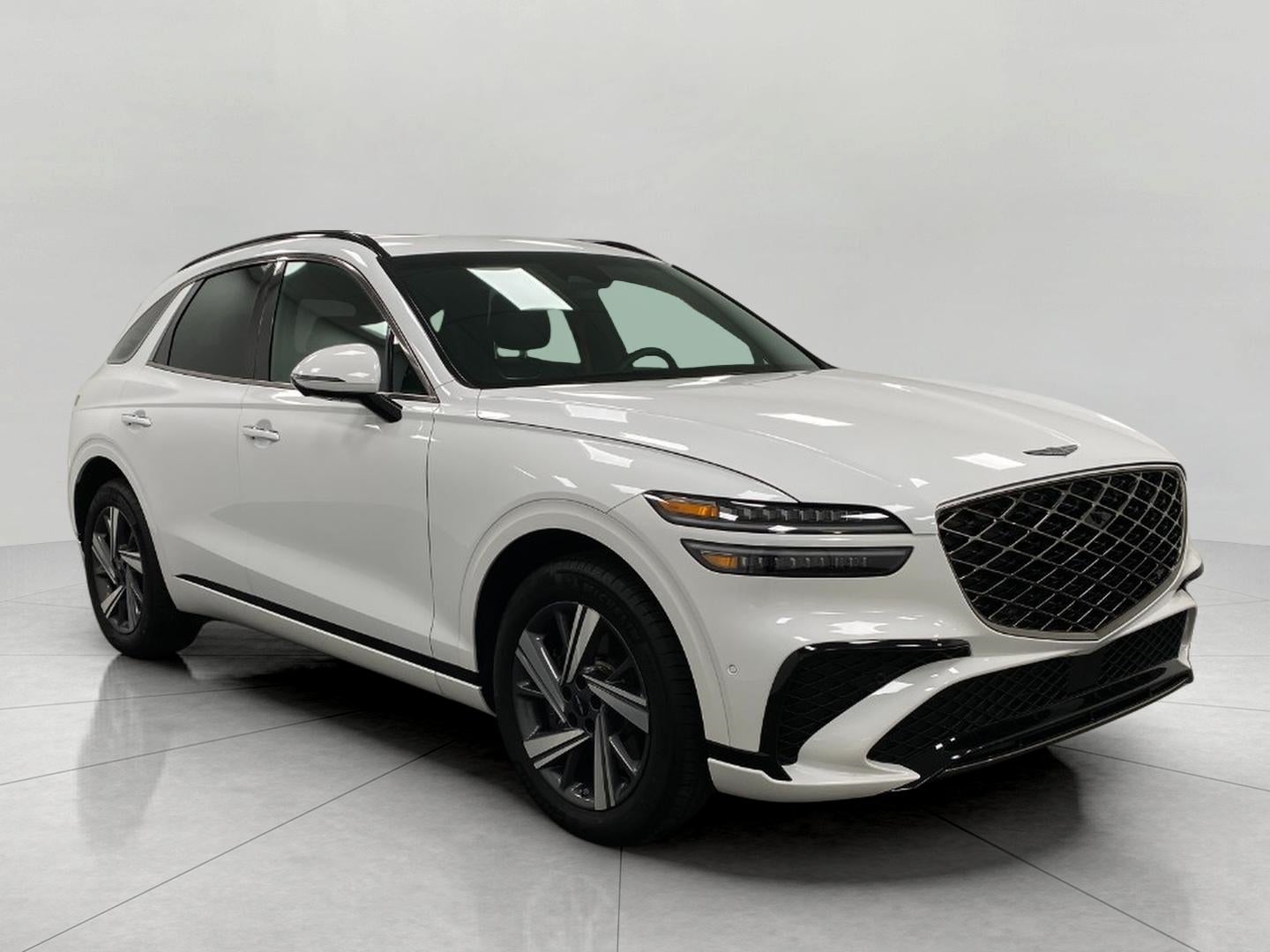 2026 Genesis GV70 3.5T Sport Advanced AWD in Uyuni White — front three-quarter view